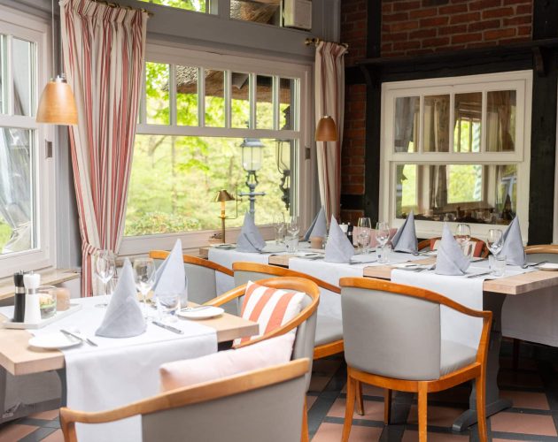 Gedeckte Tische am Fenster im Restaurant im Hotel Mellingburger Schleuse