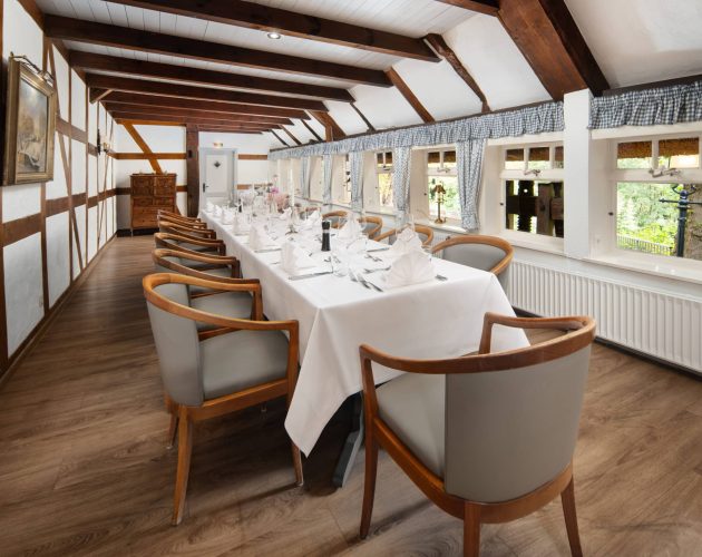 Lange Tafel, eingedeckt für eine Feier im Raum Bauernstube